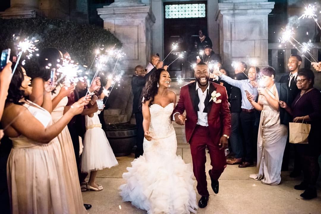 A real Char Bridals couple celebrating during their sparkler wedding exit