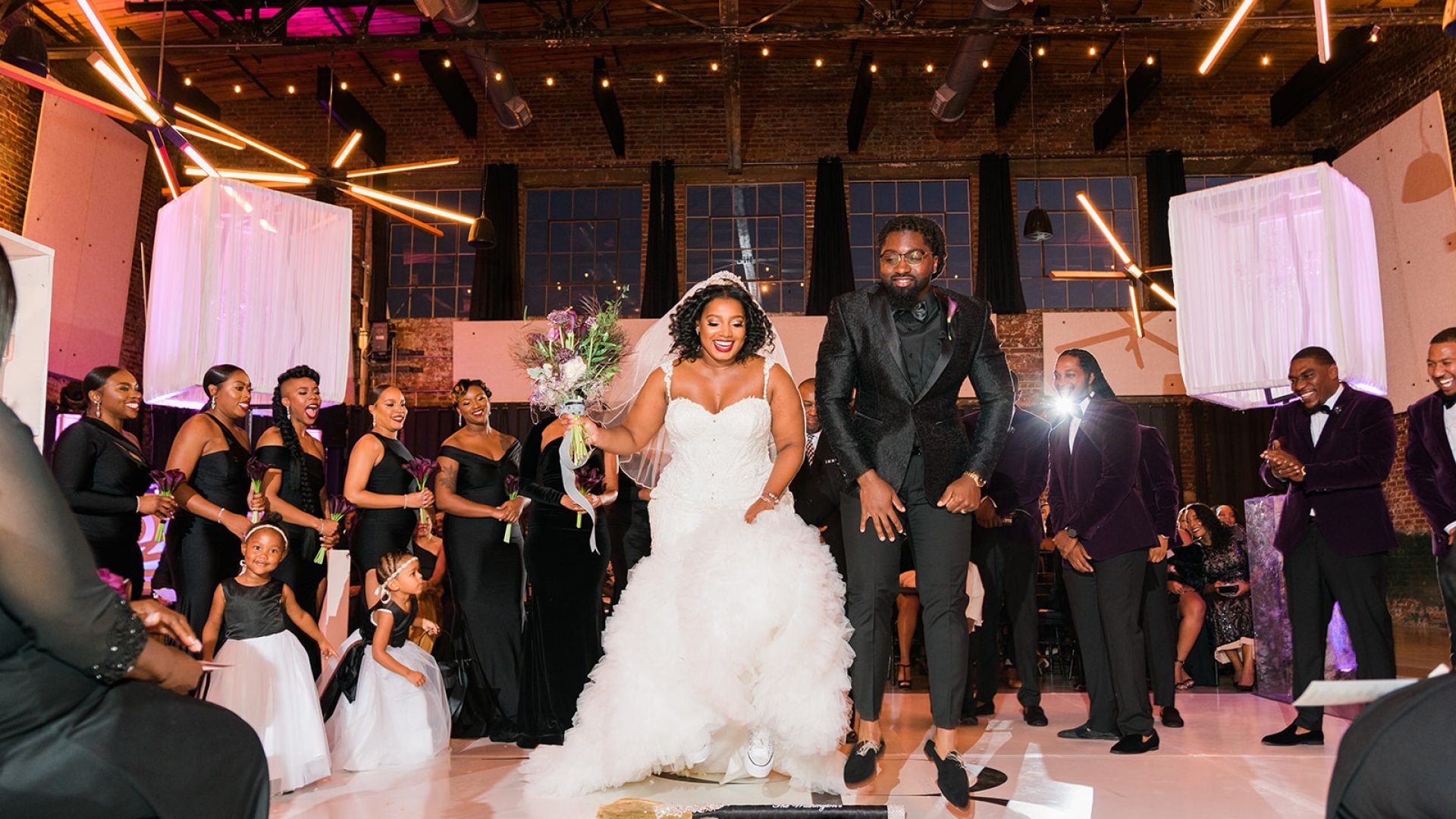 A real Char Bridals bride and groom celebrating with their wedding party